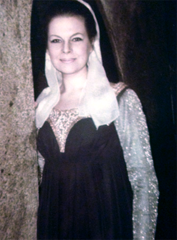 Mari Lyn Henry in medieval gown on archway